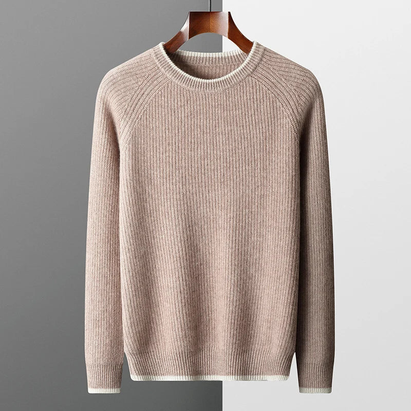 Beige sweater on a hanger against a gray background