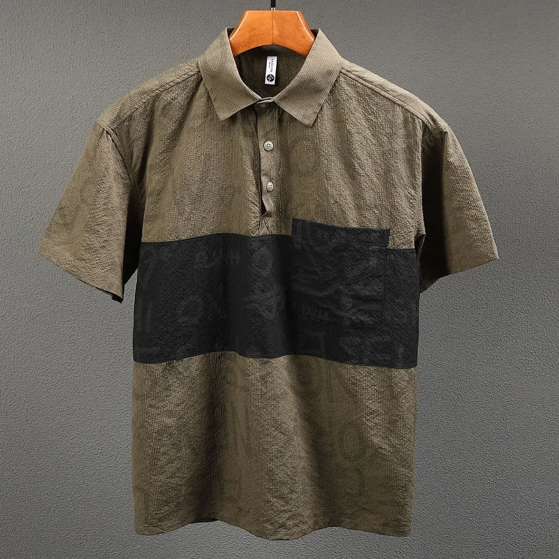Brown and black patterned shirt on a hanger against a gray background