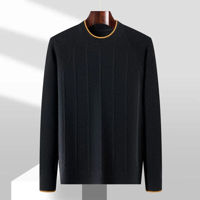 Black sweater on a hanger against a gray background