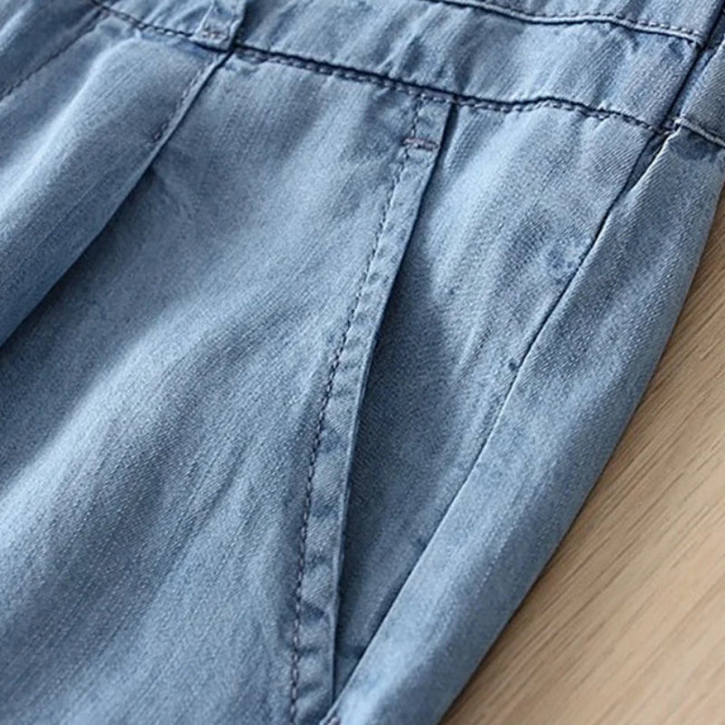 Close-up of blue denim fabric on a wooden surface