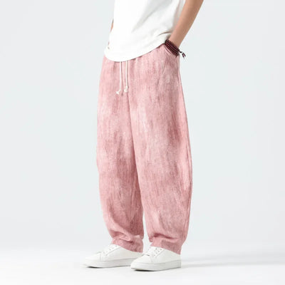 Pink pants worn by a person on a white background