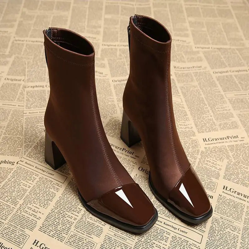 Brown high-heeled boots on a newspaper background