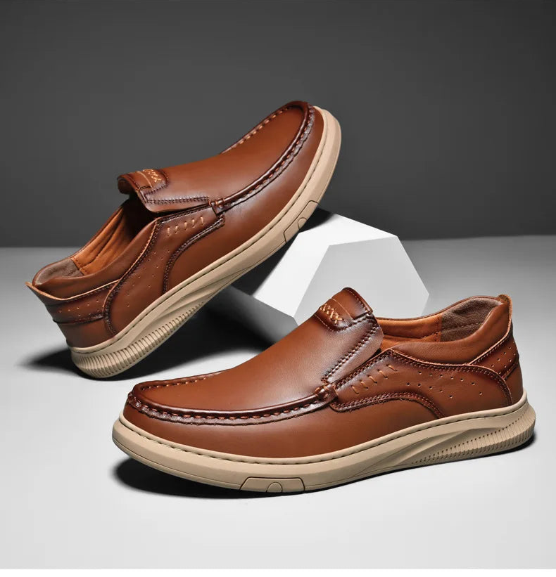 Pair of brown leather shoes on a gray background