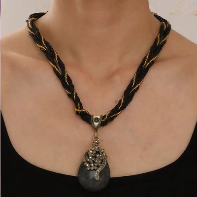 Necklace with braided design and pendant on a mannequin