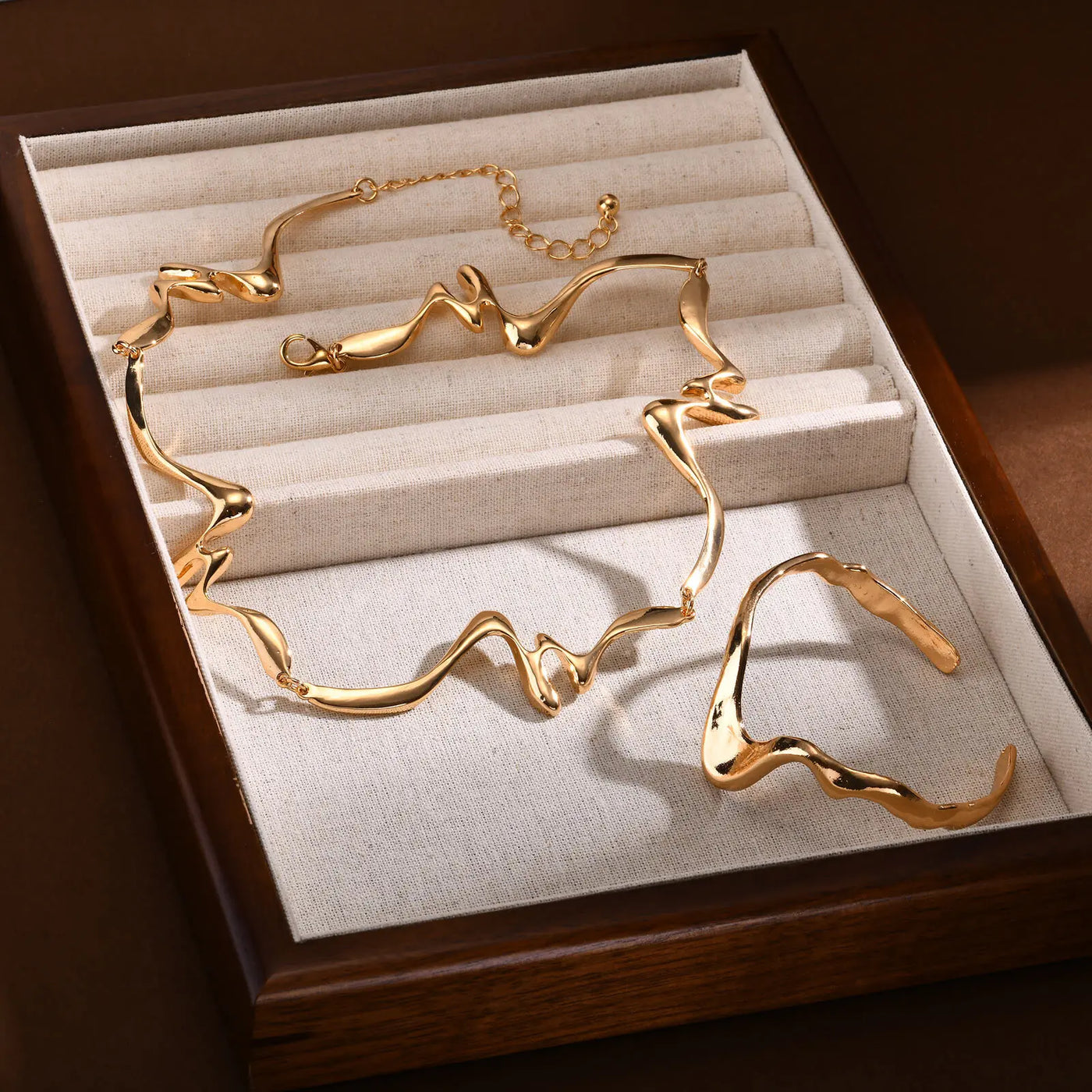 Gold necklace and earrings set in a jewelry box