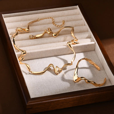 Gold necklace and earrings set in a jewelry box