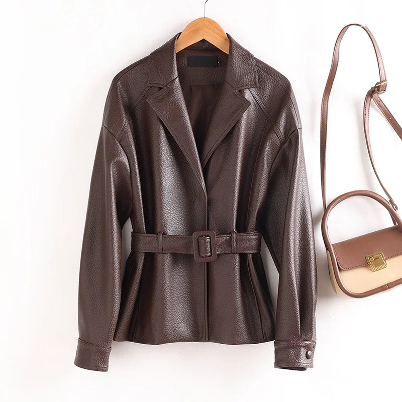 Brown leather jacket with a belt and a matching handbag on a white background