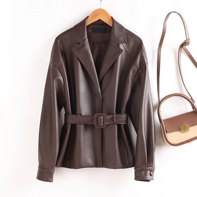 Brown leather jacket with a belt and a matching handbag on a white background