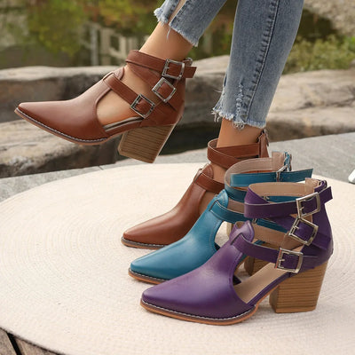 Three pairs of colorful heeled shoes on a stone surface with blurred natural background