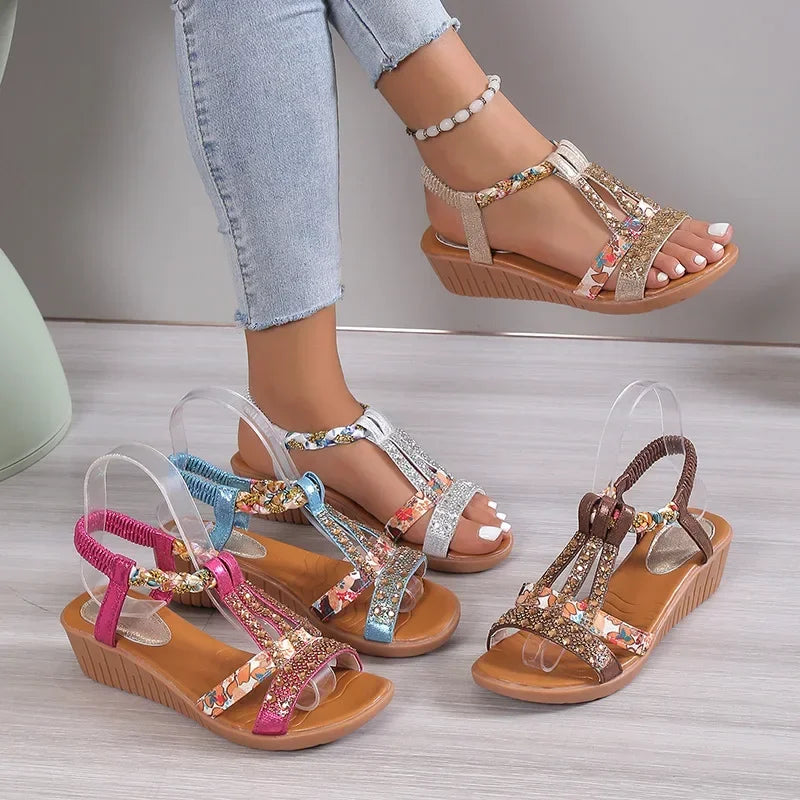 Decorative sandals with embellishments on a light wooden floor.