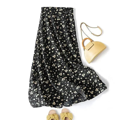 Black floral skirt with a yellow handbag and shoes on a white background