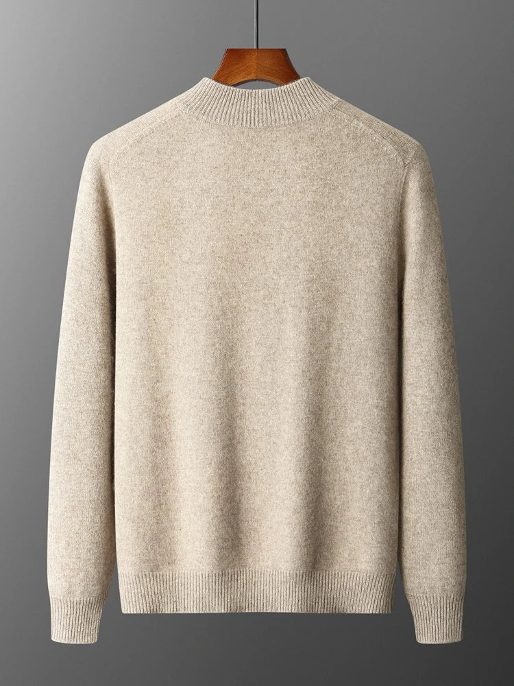 Beige sweater on a wooden hanger against a gray background
