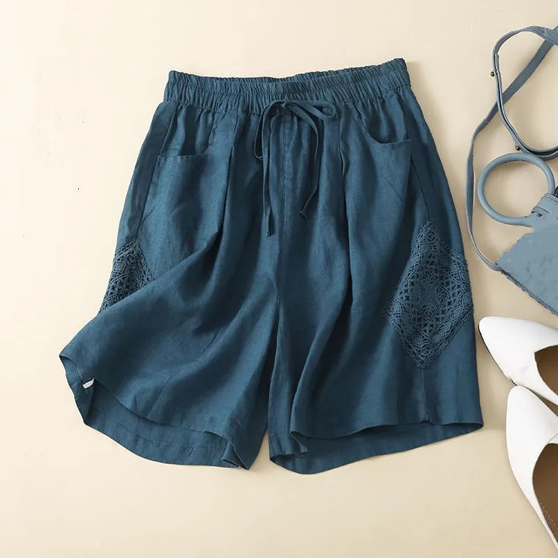 Blue shorts with lace detailing on a beige background