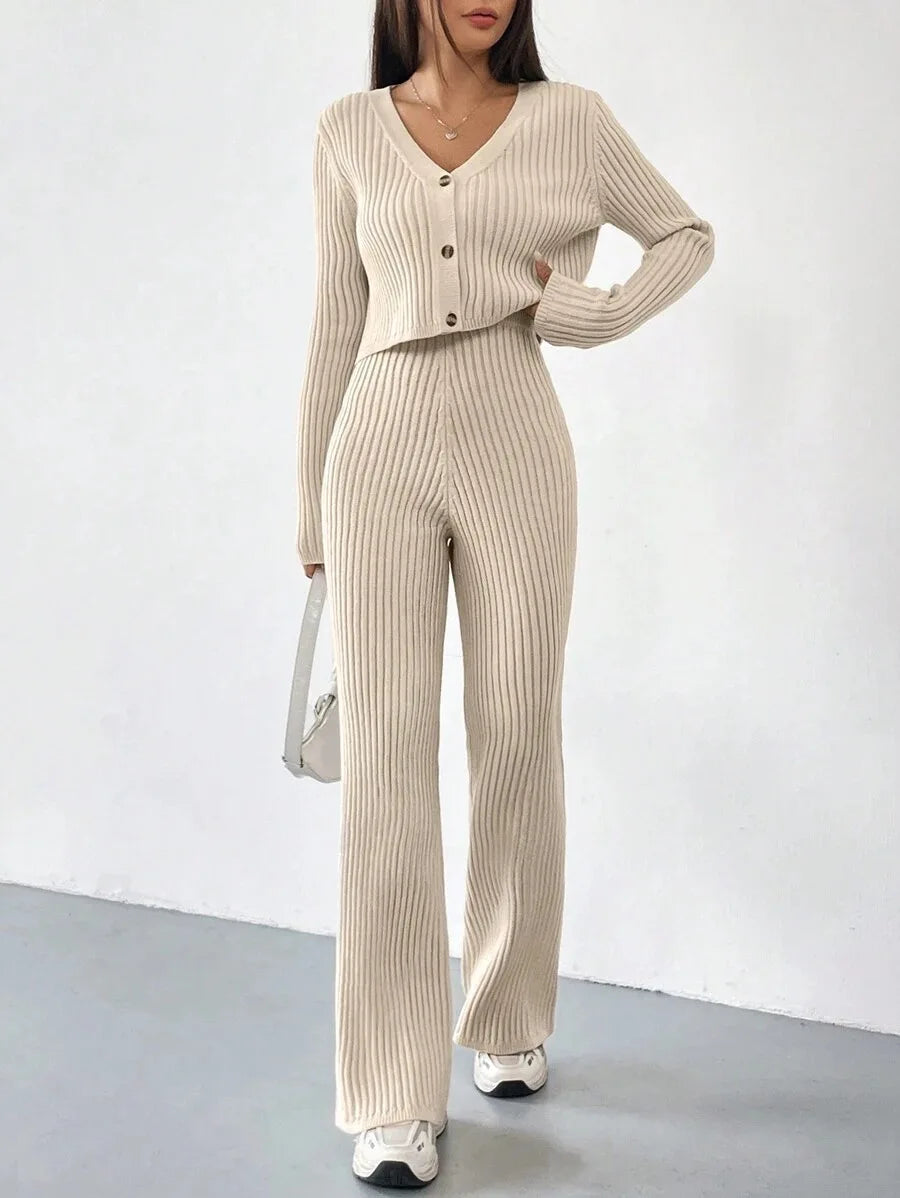 Woman wearing a beige ribbed knit two-piece set on a white background