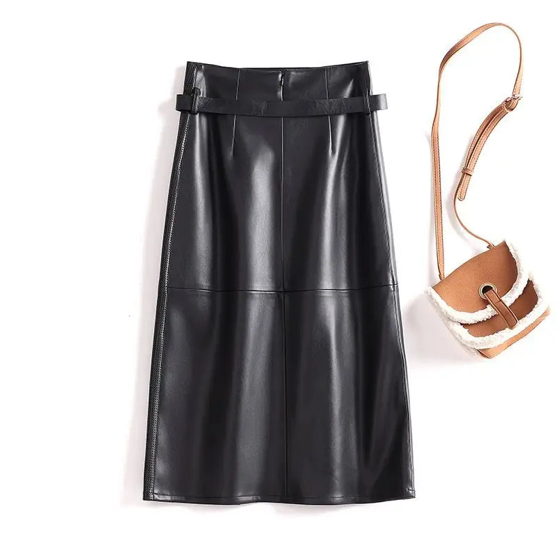 Black leather skirt with a brown and beige handbag on a white background