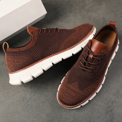 Brown sneakers with white soles on a gray surface
