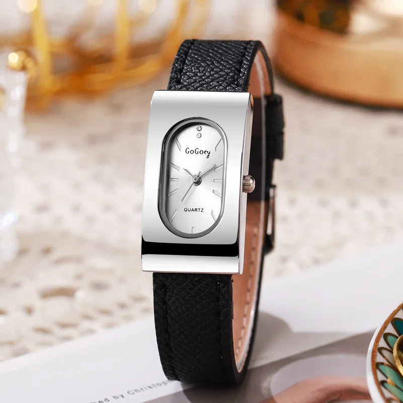 Wristwatch with black strap and silver case on a blurred background