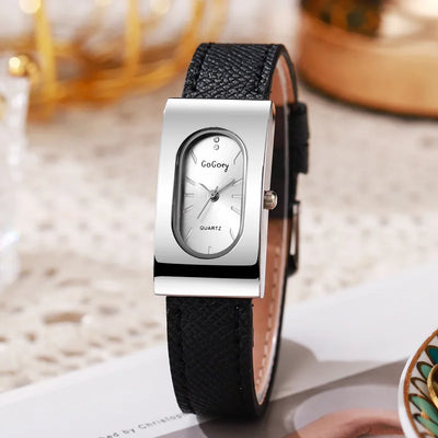 Wristwatch with black strap and silver case on a blurred background