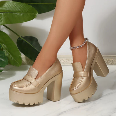 Gold platform shoes worn by a person with a plant in the background