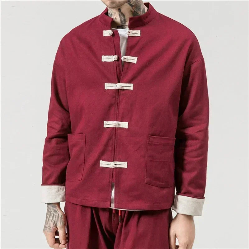 Maroon traditional outfit with white buttons on a plain background