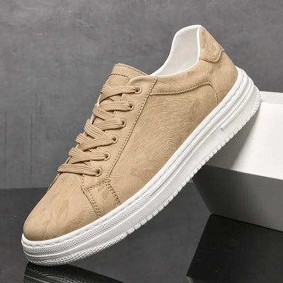 Beige sneaker with white sole on a dark surface