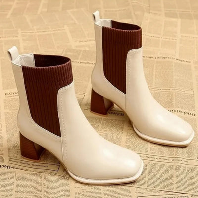 White ankle boots with brown accents on a newspaper background