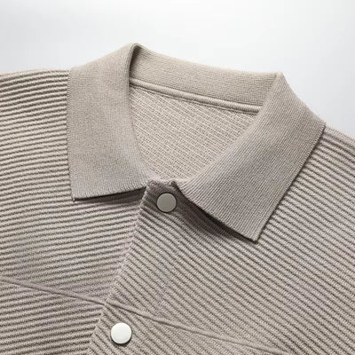 Close-up of a beige striped shirt with a collar on a white background