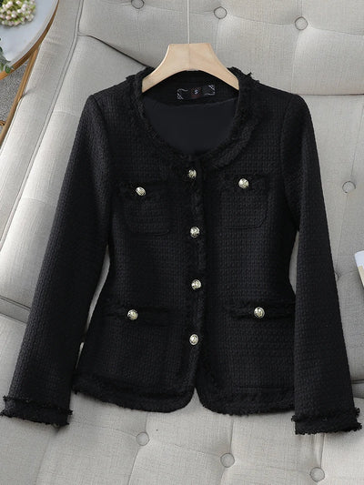 Black textured jacket with silver buttons on a gray upholstered chair