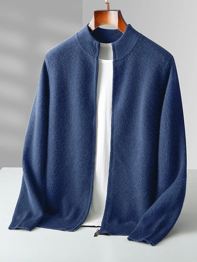 Blue sweater on a hanger against a gray background