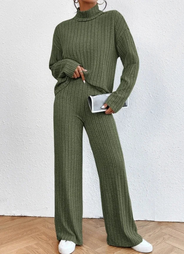 Person wearing a green ribbed knit outfit against a white background
