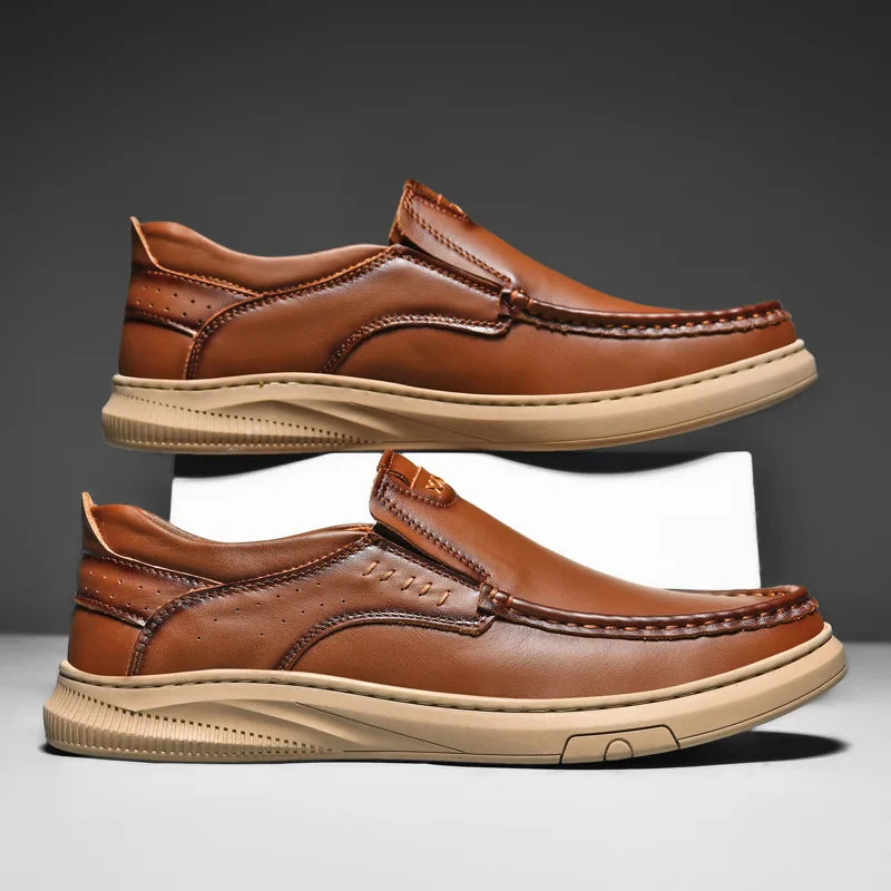 Pair of brown leather shoes on a gray background