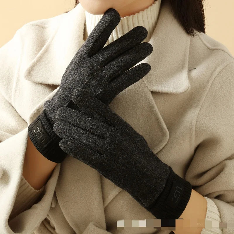 Person wearing black gloves with a beige coat