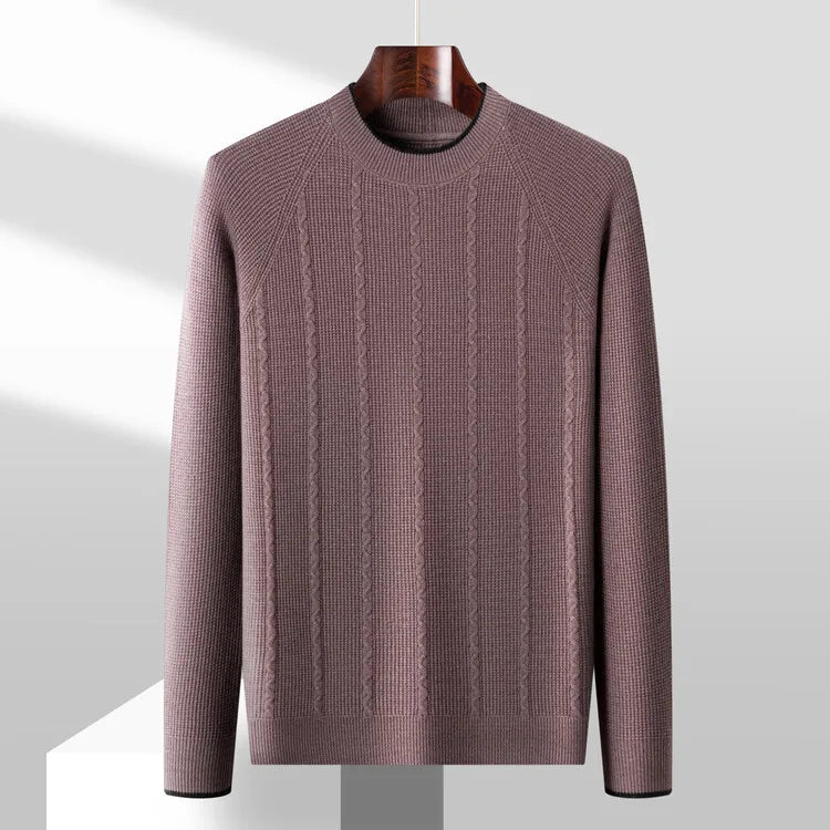 Brown cable knit sweater on a hanger against a light gray background