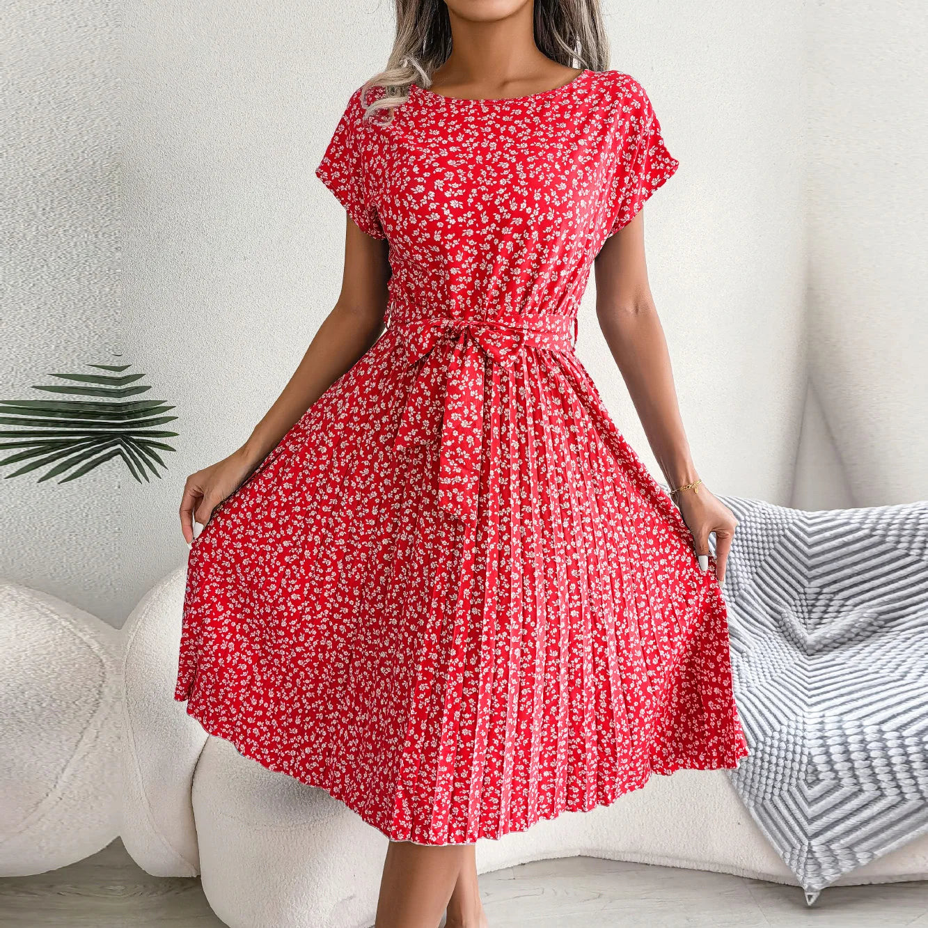 Red floral dress worn by a person against a neutral background