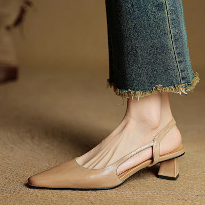 Beige sandal worn with blue jeans on a neutral background