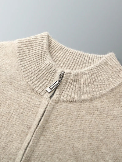 Close-up of a beige sweater with a zipper on a gray background