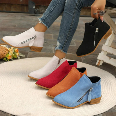 Colorful ankle boots displayed on a white surface with a blurred background.