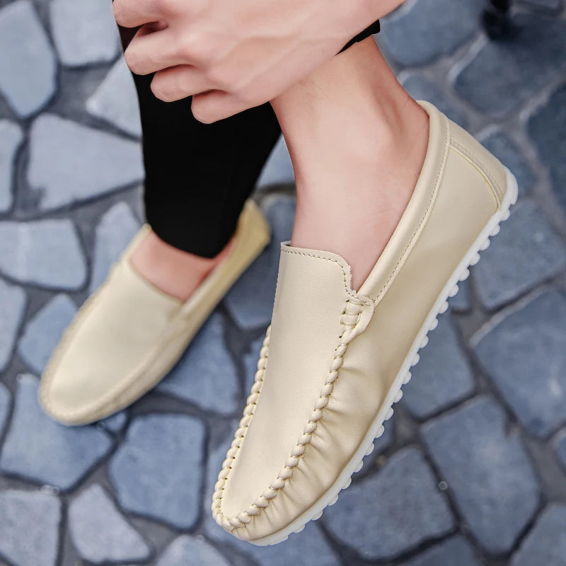 Beige loafers worn on a stone pavement