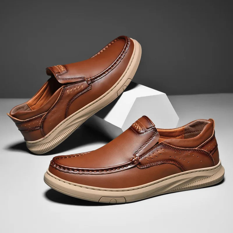 Pair of brown leather shoes on a gray background
