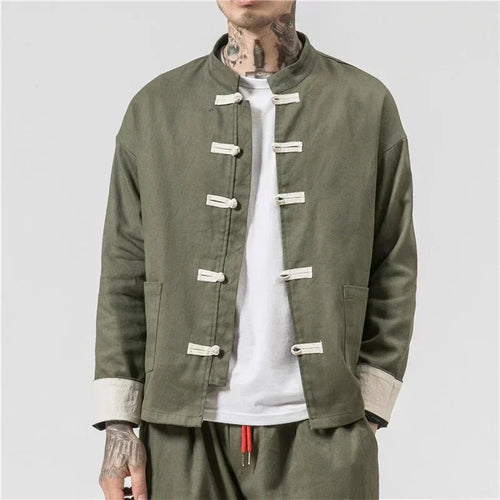 Person wearing a green jacket with button details on a plain background