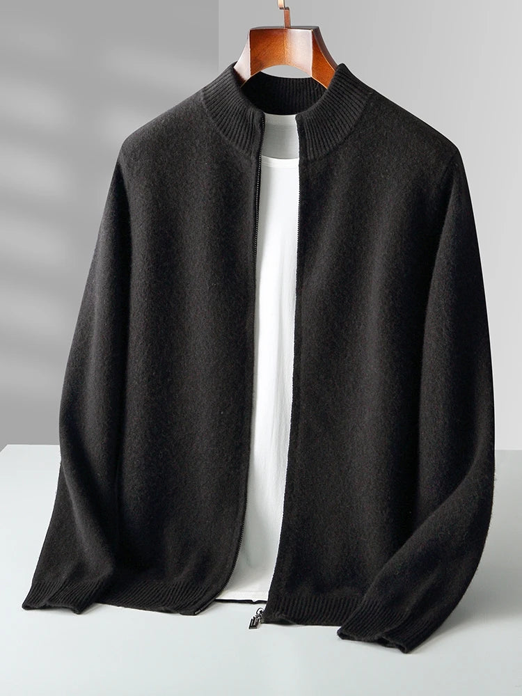 Black sweater on a hanger against a gray background