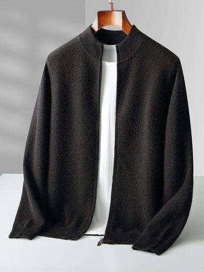 Black sweater on a hanger against a gray background