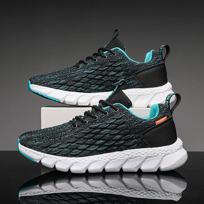 Pair of black and teal running shoes with white soles on a reflective surface.