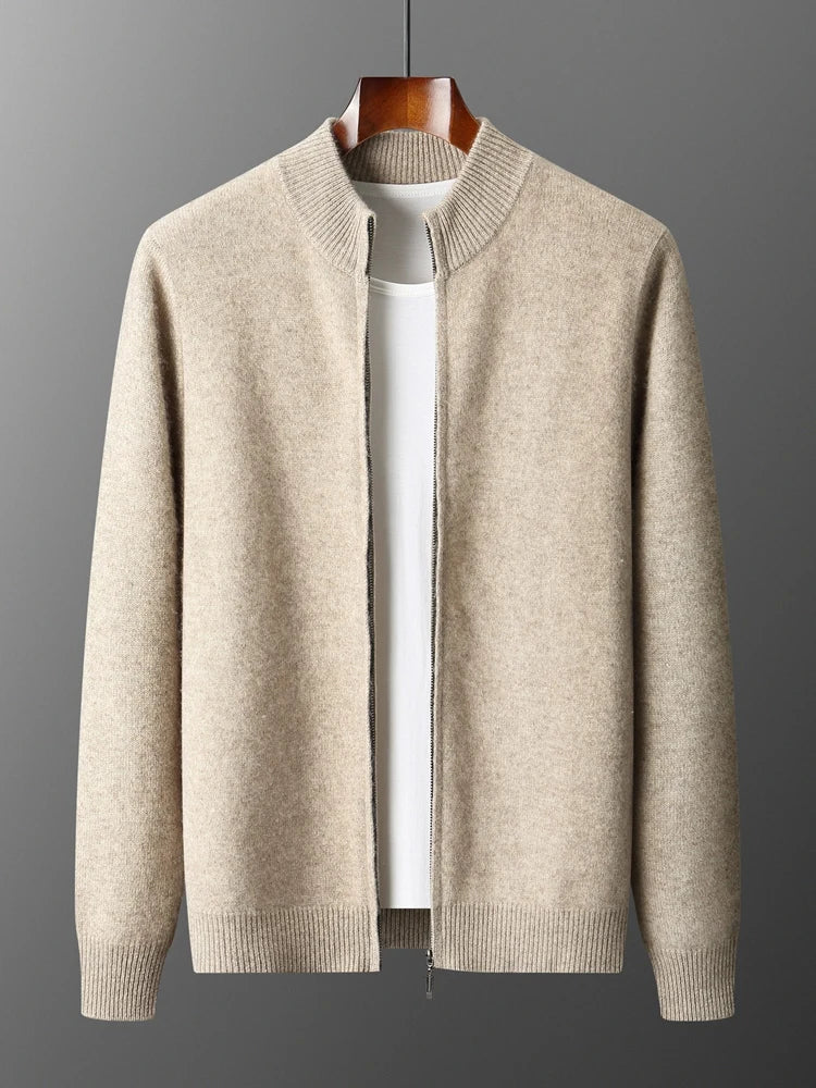 Beige sweater on a hanger against a gray background