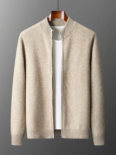 Beige sweater on a hanger against a gray background