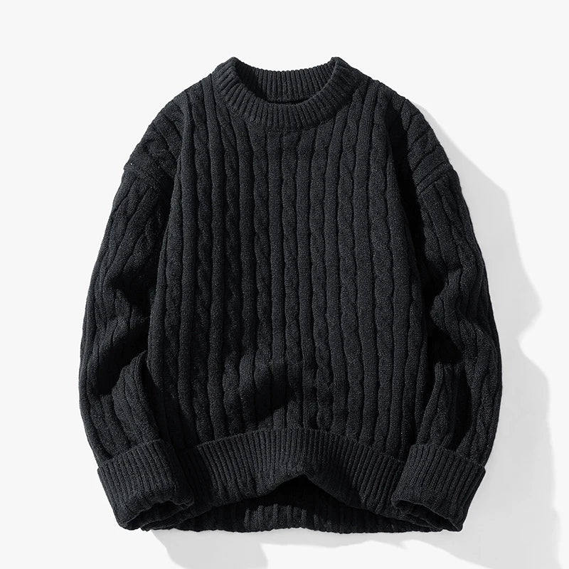 Dark gray cable knit sweater on a white background