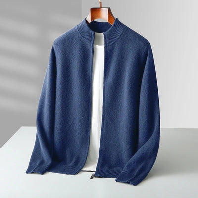 Blue sweater on a wooden hanger against a gray background