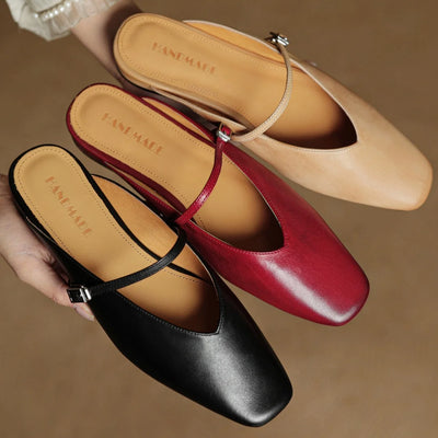 Three pairs of flat shoes in black, red, and beige on a brown background.