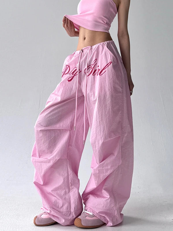 Person wearing pink pants with 'Pig Girl' text on a plain background