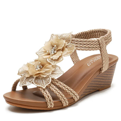 Beige sandal with floral decorations on a white background